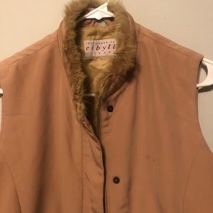 Nice vest wit fur on collar. Little oil stain.